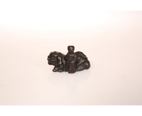 A JAPANESE WOOD SHISHI NETSUKE, probably 19th Century, carved with boy, signed. 45mm