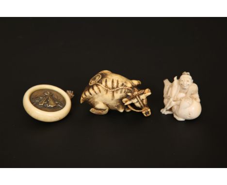 A RARE JAPANESE IVORY AND METAL KAGAMIBUTA NETSUKE, together with TWO FURTHER IVORY NETSUKES of an oxen and man with gourd. (