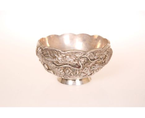 A CHINESE SILVER DOUBLE WALLED BOWL, embossed with a three-claw dragon, seal marks. 7.2oz, 13cm wide