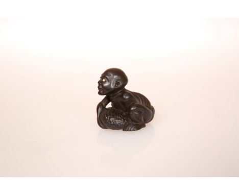 A JAPANESE WOOD NETSUKE OF A BLIND BEGGAR, 19th Century, with inlaid eye, signed to a rectangular reserve. 36mm