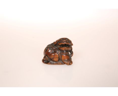 A JAPANESE WOOD NETSUKE OF A SHISHI, 19th Century. 41mm