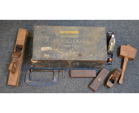 A 1939 Pioneer Corps. wooden trunk housing a collection of vintage woodworking tools including planes, mallets, oil stones et