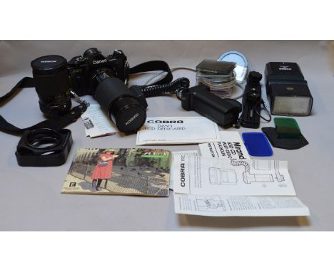 A Canon AE-1 camera with Ozeck II 1:56 f=75-300mm lens and 1:3.5-5.5 f=28-100mm lens and accessories.