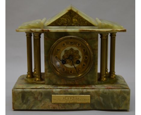 A late 19th century/early 20th century French movement marble cased mantle clock with chimer. Enscribed plaque to front.