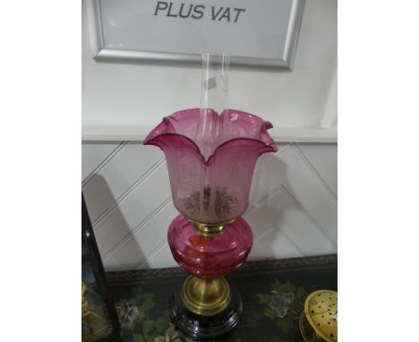 A Victorian brass and cut glass Oil Lamp, having a cut cranberry glass font and etched glass shade, on plinth base, shade chi