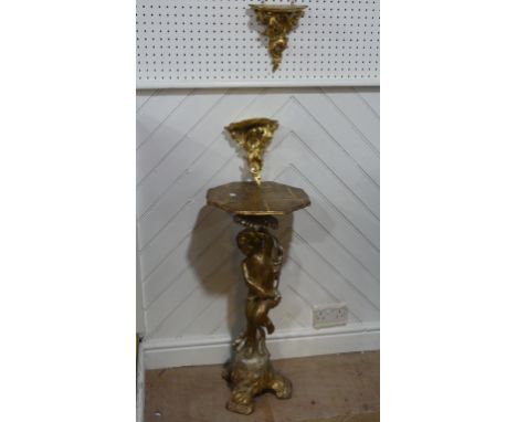 A wooden carved&nbsp;gilt painted side table,&nbsp; standing cherub to base holding octagonal table 77cm high, together with 