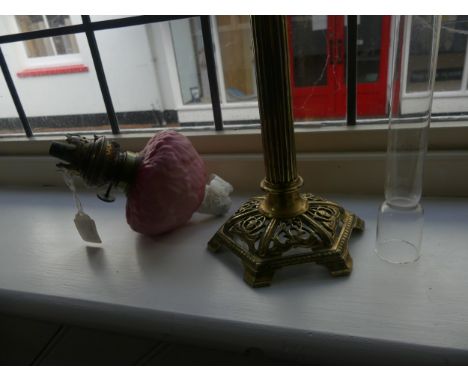 A brass Peg Lamp Base, in the form of a column, with an opaque blue font and associated shade, relief decorated with flowers,