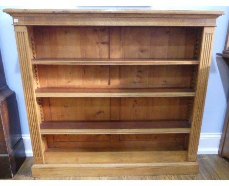 An Edwardian light oak open Bookcase, with three adjustable shelves flanked by pilasters on plinth base, W:128cm x D:29cm x H