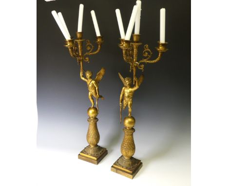 A pair of late 19th century French gilt metal four branch figural Candelabra, the central cupid figure supporting a cornucopi