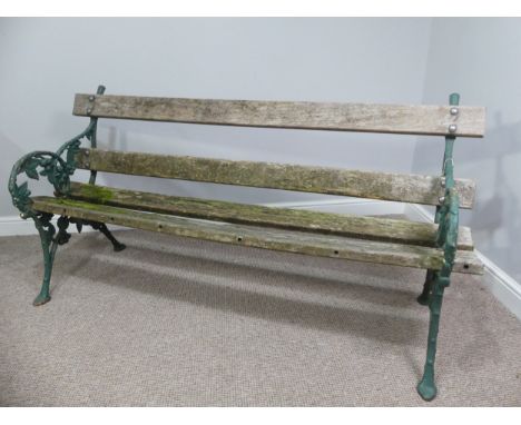 Garden Furniture; a vintage green-painted cast iron Garden Seat, the bench ends in the Coalbrookdale style with vines, in wea