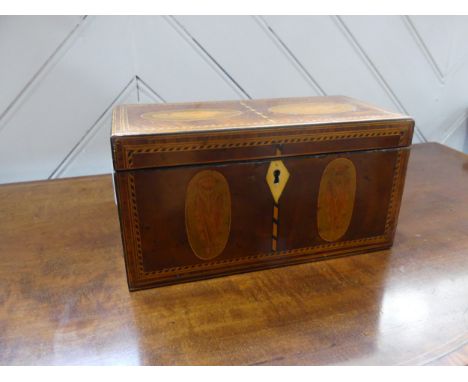 A Georgian mahogany Tea Caddy, with shell inlays and ivory escutcheon, the two section interior with lift off covers and ivor