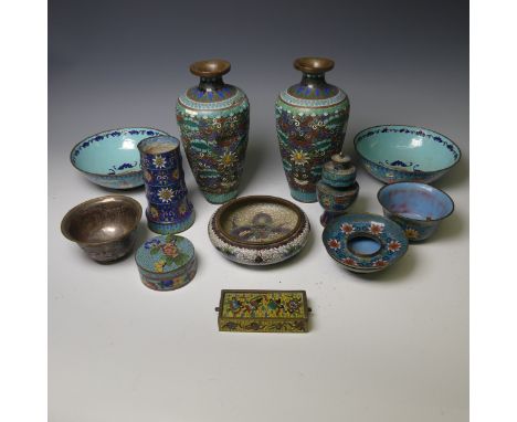A pair of oriental painted enamel Bowls, decorated in the famille rose palate with flowers on a pale blue ground, 17.5cm diam
