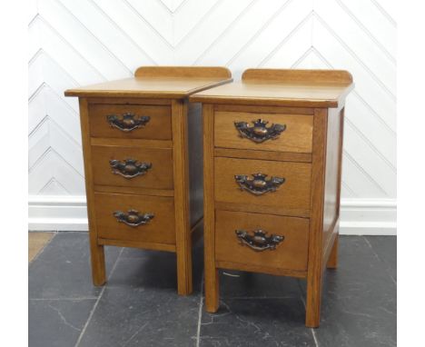 A pair of Arts &amp; Crafts light oak three-drawer Bedside Cabinets, fitted with later embossed brass handles, W:37cm x H:66c