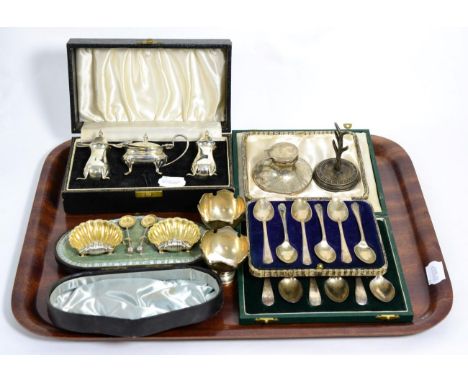 Assorted silver comprising a cased three piece condiment set, a cased pair of shelf form salts, two sets of cased teaspoons, 