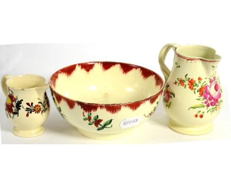 Two creamware jugs and a slop basin 