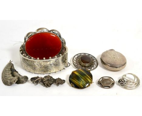 A silver hinge opening bangle, a Victorian locket pendant, three hardstone brooches, a Rennie Mackintosh style brooch, a Char