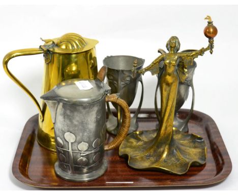 A Liberty & Co pewter hot water jug, a pair of Continental pewter vases, an Art Nouveau figural table lighter and a brass jug