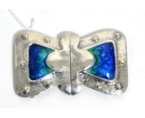 A Liberty & Co silver and enamel buckle in the form of a bow, with hammered decoration and a blue and green enamel centre, me