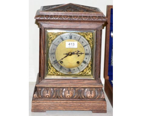 A carved oak quarter striking table clock, retailed by J Dwerryhouse Liverpool, movement stamped W & H 