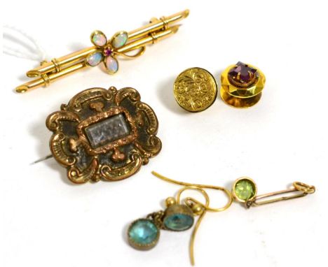 An opal and ruby bar brooch, a pair of garnet set dress buttons, a mourning brooch, a peridot pendant and a pair of paste set