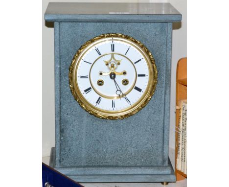 A grey slate striking mantel clock 