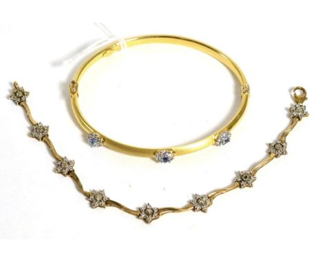 A gem set bangle stamped '750' and a diamond set bracelet (a.f.)Bangle 4.8g, bracelet 4.4g