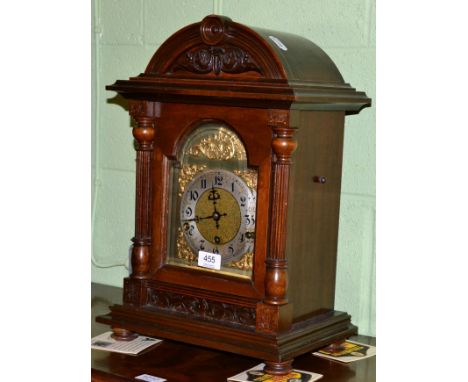 A mahogany bracket clock, the arched dial flanked by fluted supports