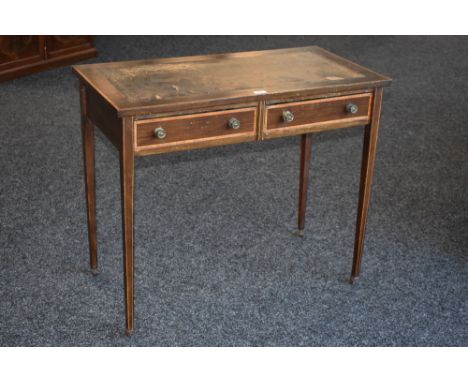 An Edwardian satinwood crossbanded mahogany writing table, retailed by Eddershaws House Furnishers, Swansea, oversailing top 