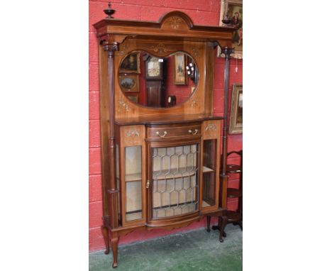 A Sheraton revival display cabinet, arched pediment, turned finials, kidney shaped mirror to top, projecting bowed  breakfron