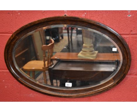 An oak framed bevel glass mirror