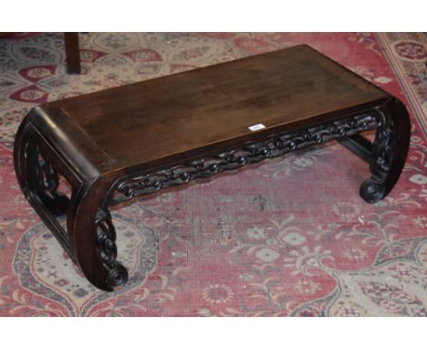 A Chinese hardwood rectangular low tea table, rectangular top with scroll ends, pierced and carved with clouds, 33.5cm high, 