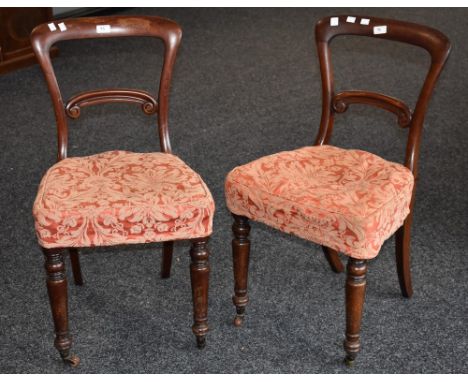 A set of nine Victorian mahogany balloon back dining chairs, horizontal splats, stuffed overseat, turned forelegs, ceramic ca