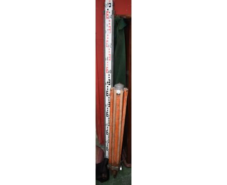 A Kern surveyors dumpy sighting level, cased,  tripod and measuring staff (3)