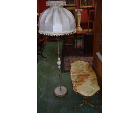 A retro gilt metal and onyx serpentine coffee table; an onyx and gilt metal standard lamp. (2)