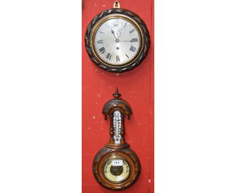 A Victorian carved walnut wall barometer with thermometer, arched pediment, turned finial, 40cm high; a circular wall clock w