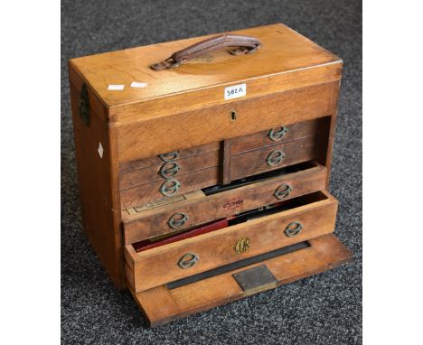 A CQR engineer's box, hinged cover to top compartment, an arrangement of seven drawers each with handles stamped CQR, assorte