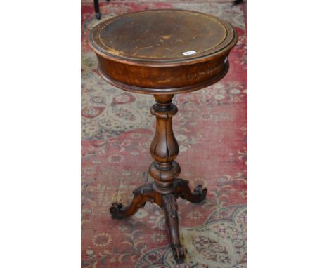 A William IV mahogany tripod work table, circular with lift-out panel enclosing a recess, lotus column, acanthus carved cabri