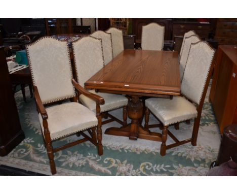 A light oak refectory draw leaf dining table by Jaycee Furniture, rectangular top, carved cup and cover supports, six oak din