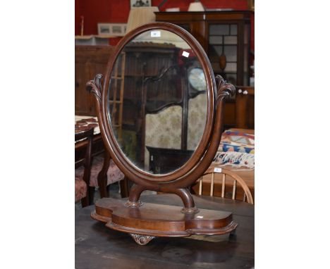 A large Victorian mahogany oval dressing table mirror