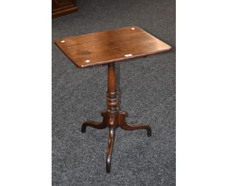 A 19th century oak rounded rectangular tilt-top tripod occasional table