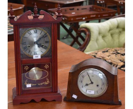 A 31 day mantel clock; an oak cased mantel clock