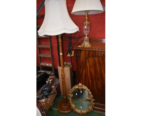 An oak standard lamp; a glass and gilt table lamp; a gilt wall mirror 