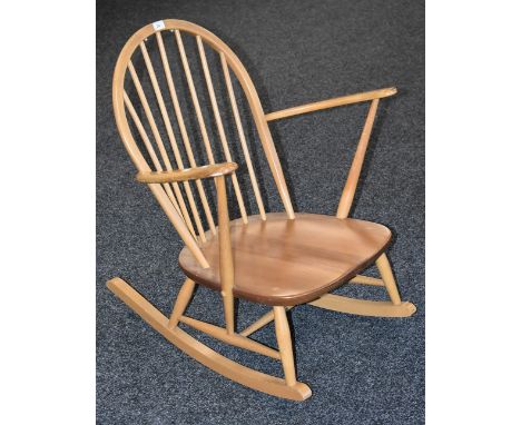 A light elm Ercol rocking chair, spindled hoop back, H-stretchers 