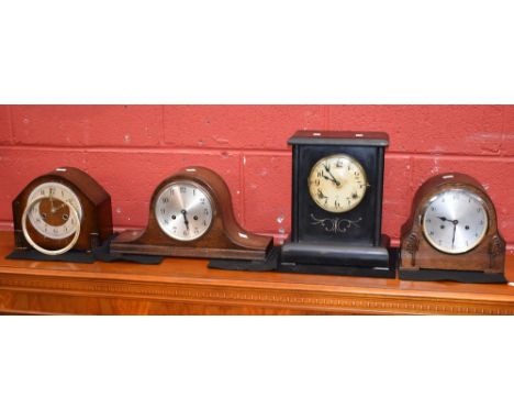An early 20th century ebonised mantel clock, circular dial inscribed with Arabic numerals, three winding holes, moulded outsw
