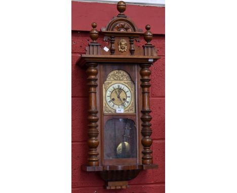 A mahogany Vienna wall clock, Roman numerals, carved pediment