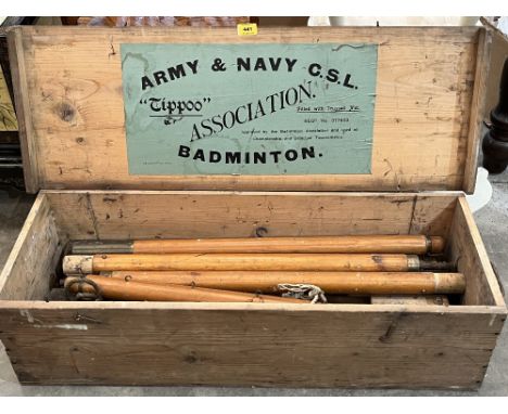 A pine boxed Army and Navy 'Tippoo' set of Badminton poles with trussed net.