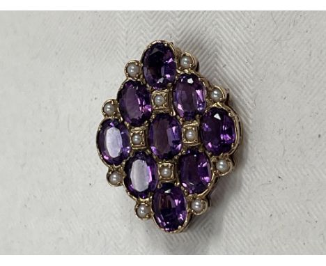 A 9ct amethyst and split pearl brooch. 29mm wide.