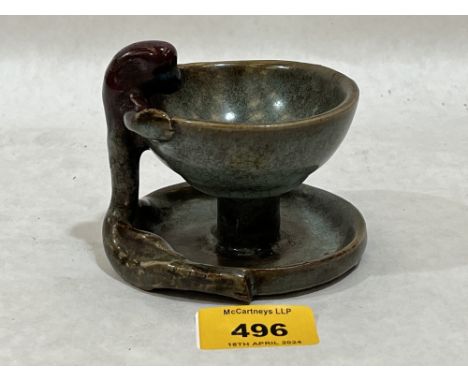 An Oriental glazed pottery bowl or lamp, with anthropomorphic handle. 3" high.