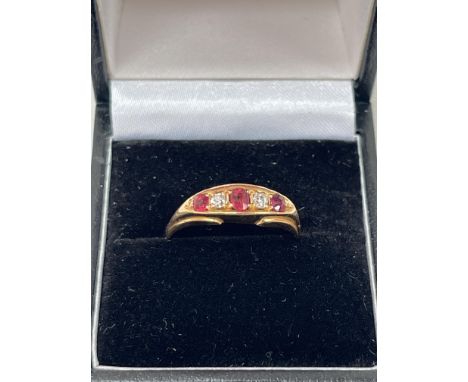 An Edwardian 18ct five stone ruby and diamond ring. 3.2g gross. Size R.