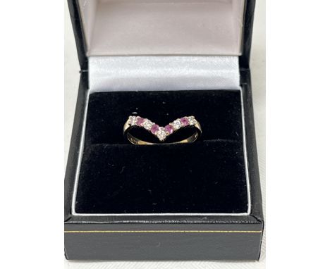 A 9ct ruby and diamond wishbone ring. 1.4g gross. Size K.
